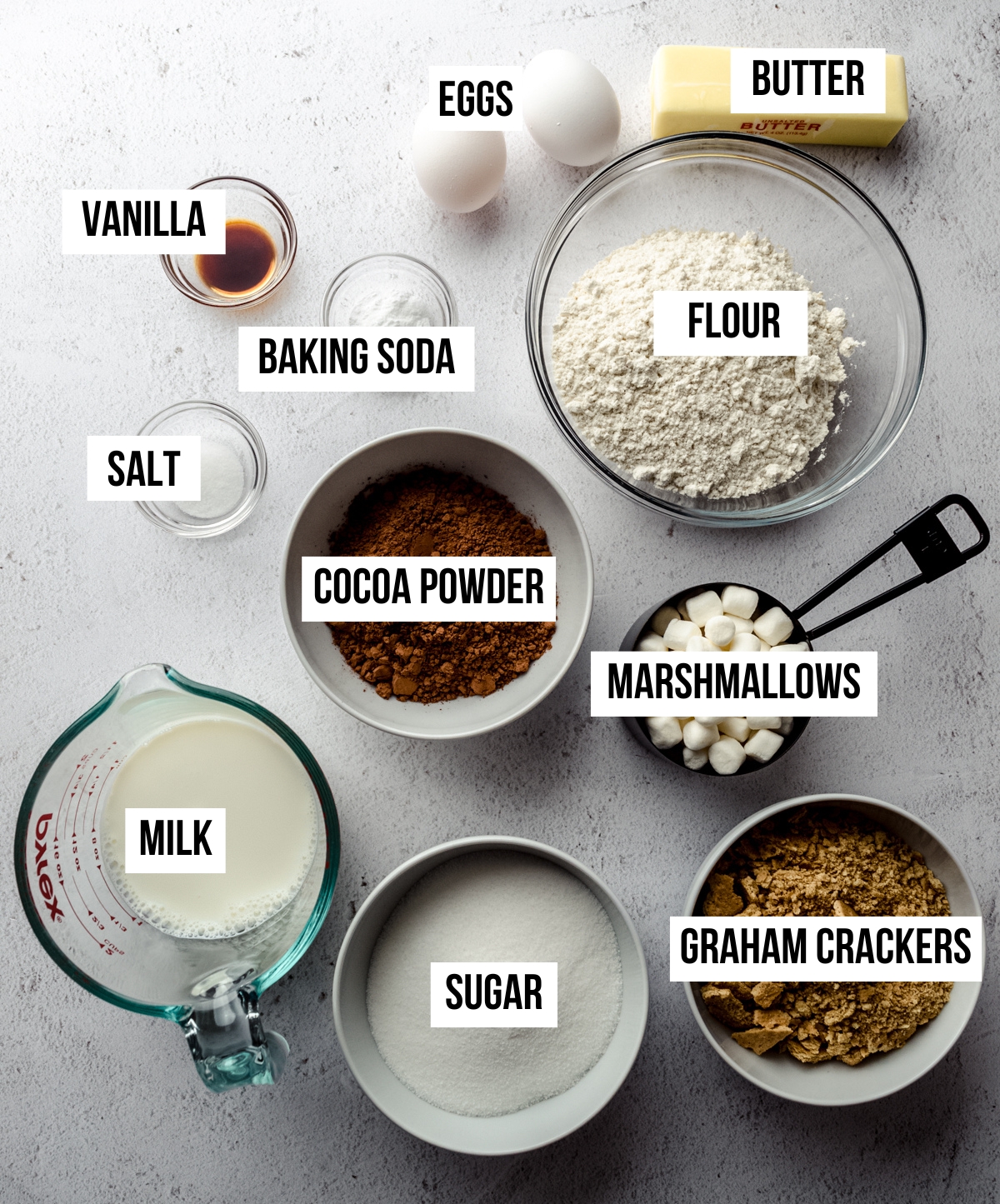 Aerial photo of ingredients for s'mores quick bread with text overlay labeling each ingredient.