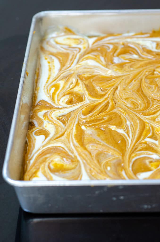 Pumpkin Cheesecake Swirl Sheet Cake: Dense and flavorful pumpkin cake swirled with sweet and creamy cheesecake.