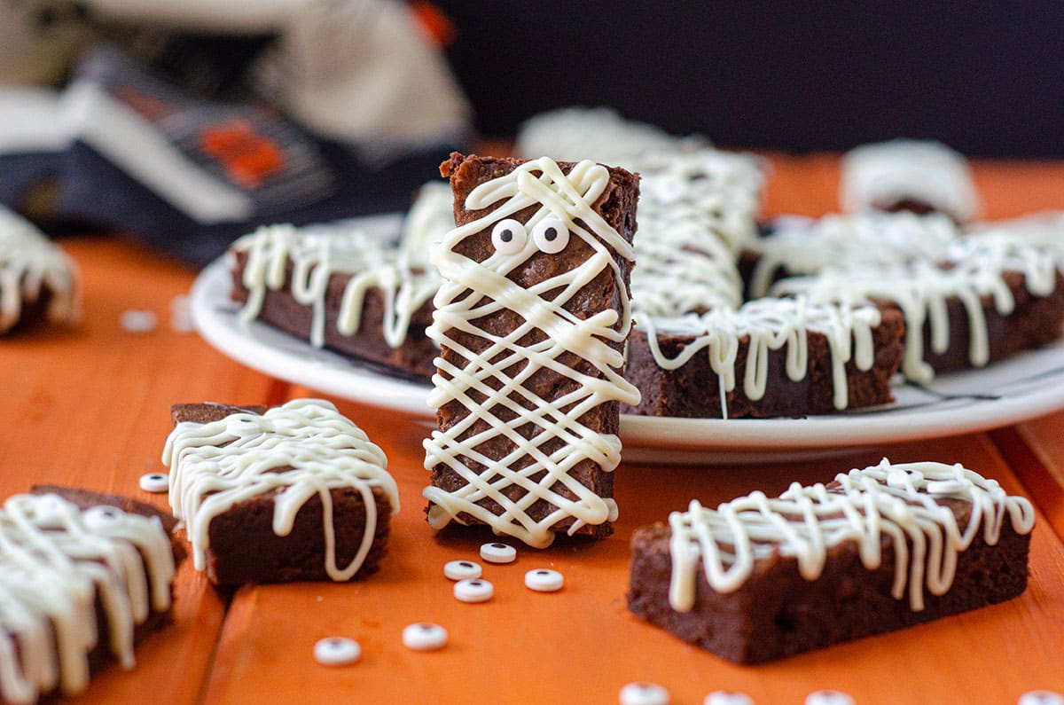 mummy brownie leaning up against a plate of brownies