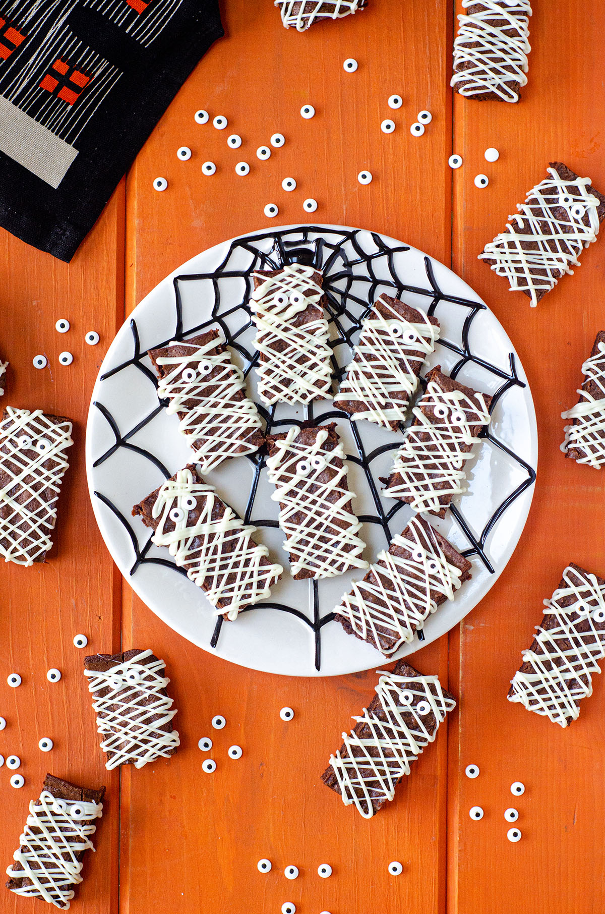 aerial photo of mummy brownies on a spider web plate