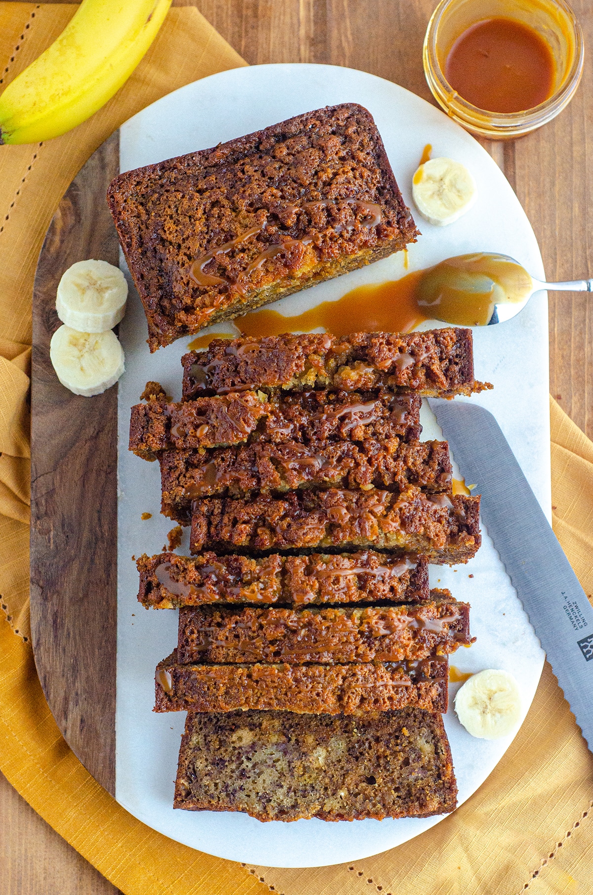 aerial photo of banana bread loaf with caramel on a spoon