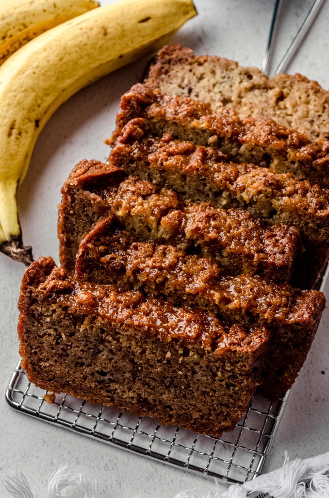 Slices of salted caramel banana bread on a cooling rack.