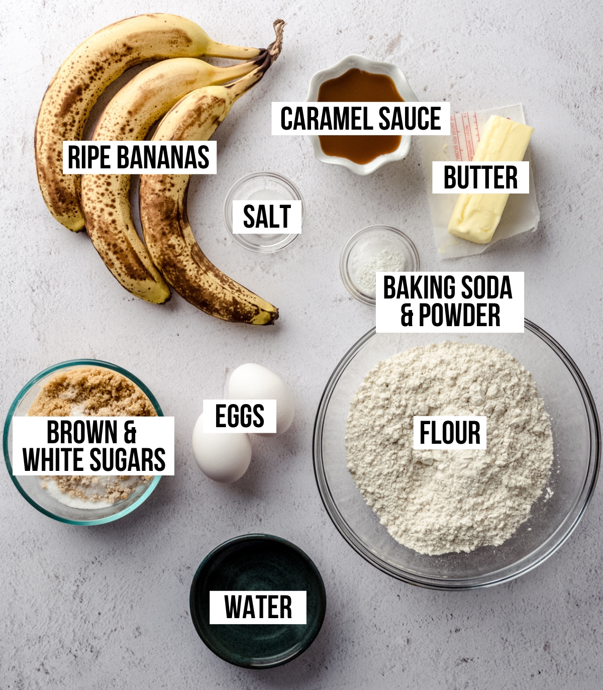 Aerial photo of ingredients to make salted caramel banana bread with text overlay labeling each ingredient.