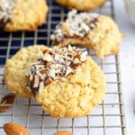 Almond Joy Coconut Cookies: Easy coconut drop cookies, dipped in chocolate and sprinkled with toasted coconut and chopped almonds.