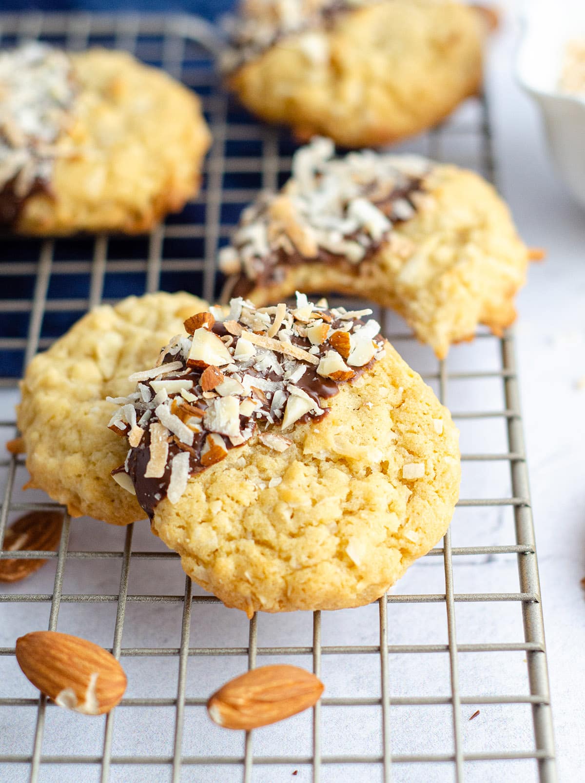 Almond Joy Coconut Cookies: Easy coconut drop cookies, dipped in chocolate and sprinkled with toasted coconut and chopped almonds.