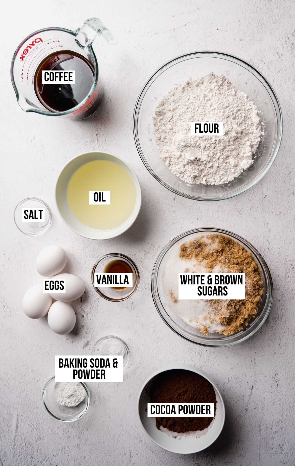Aerial photo of ingredients to make a chocolate Bundt cake with text overlay labeling each ingredient.
