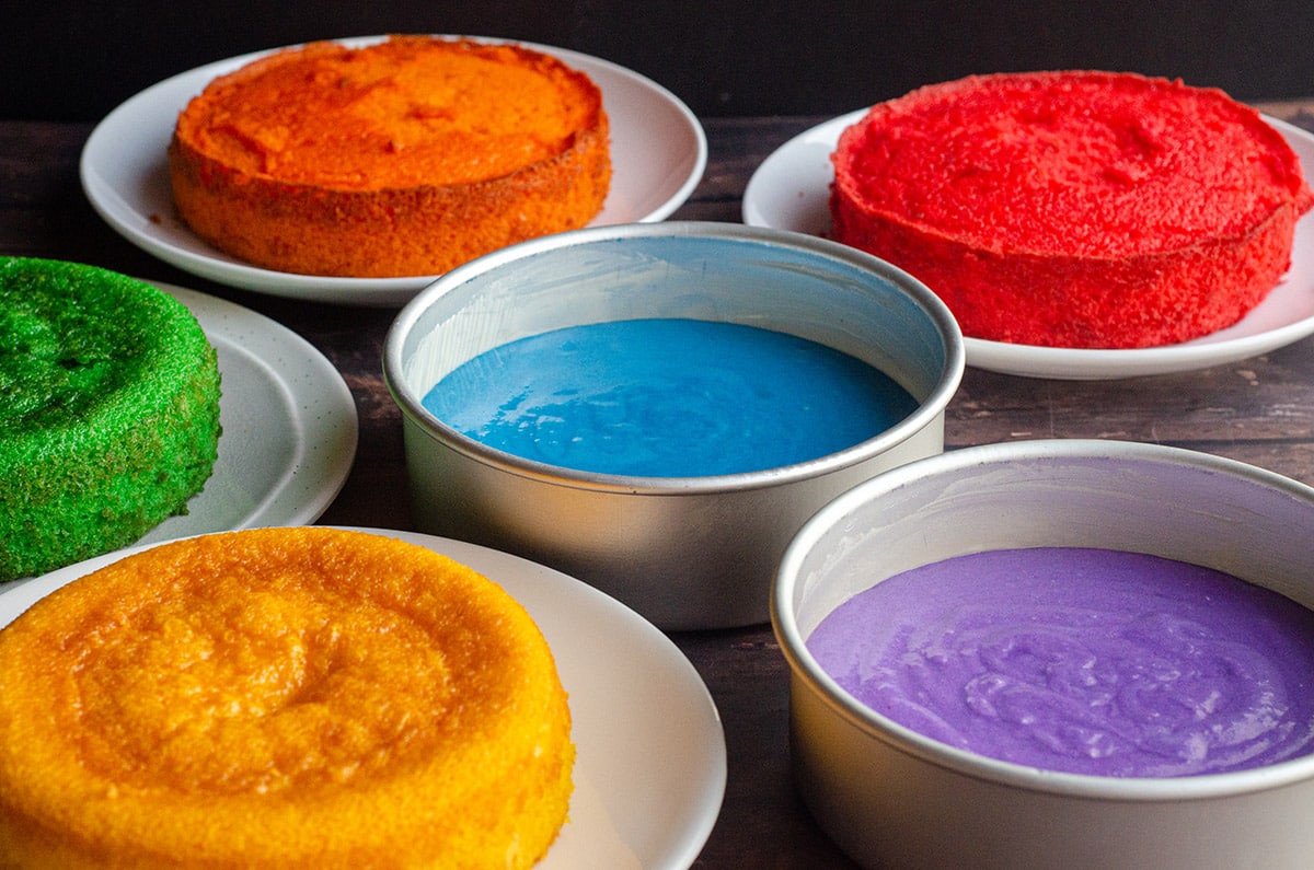 pans filled with batter for a rainbow cake