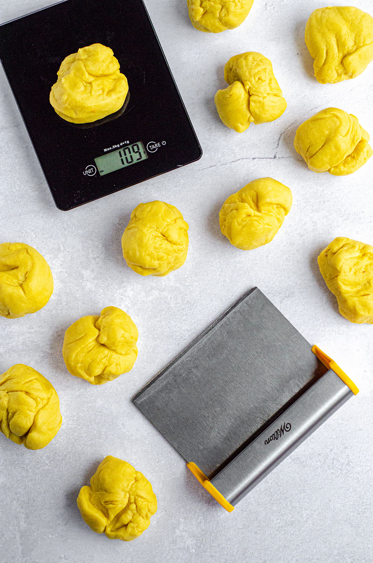 aerial photo of pieces of saffron bun dough prepared to form into bun shapes