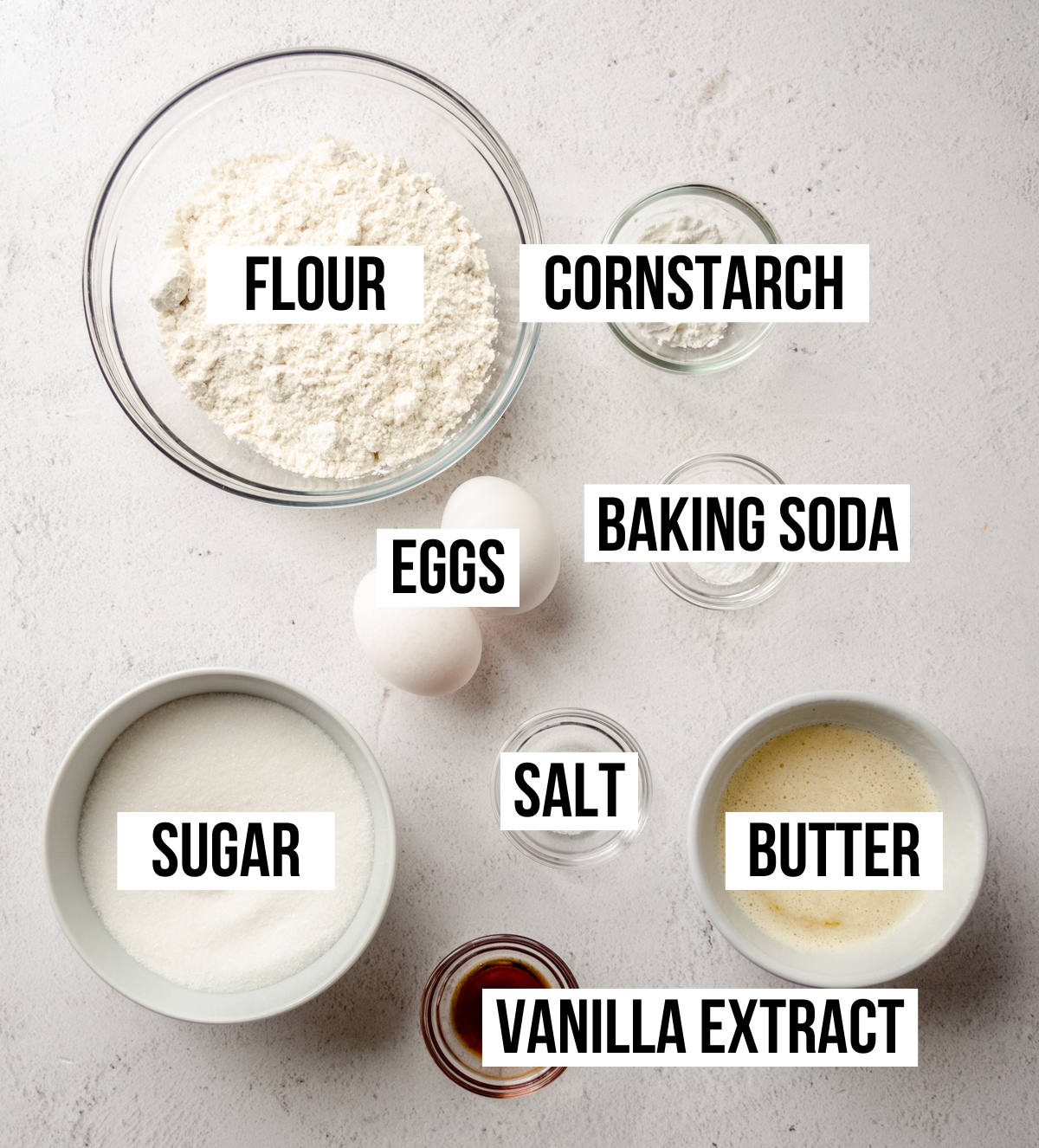 Aerial photo of ingredients to make sugar cookie bars with text overlay labeling each ingredient.