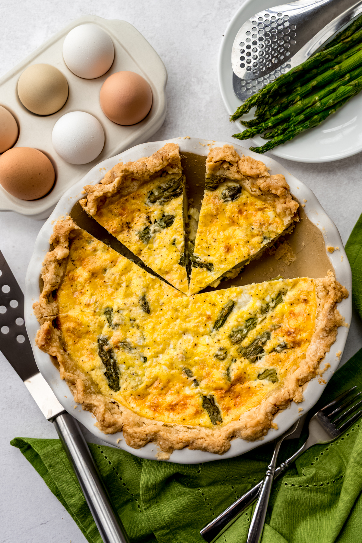 Aerial photo of an asparagus quiche that has been sliced.