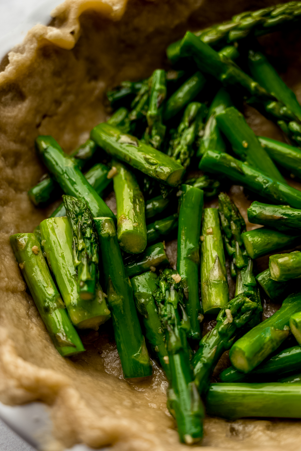 Chopped asparagus stalks in a pie crust to make quiche.