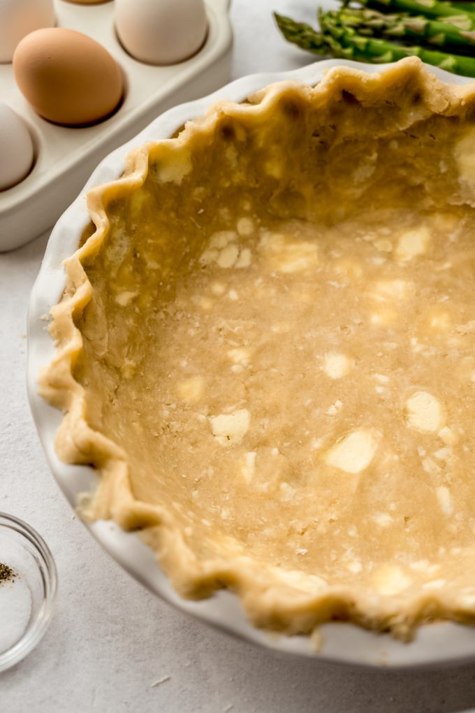 A pie crust in a pie plate to make a quiche.