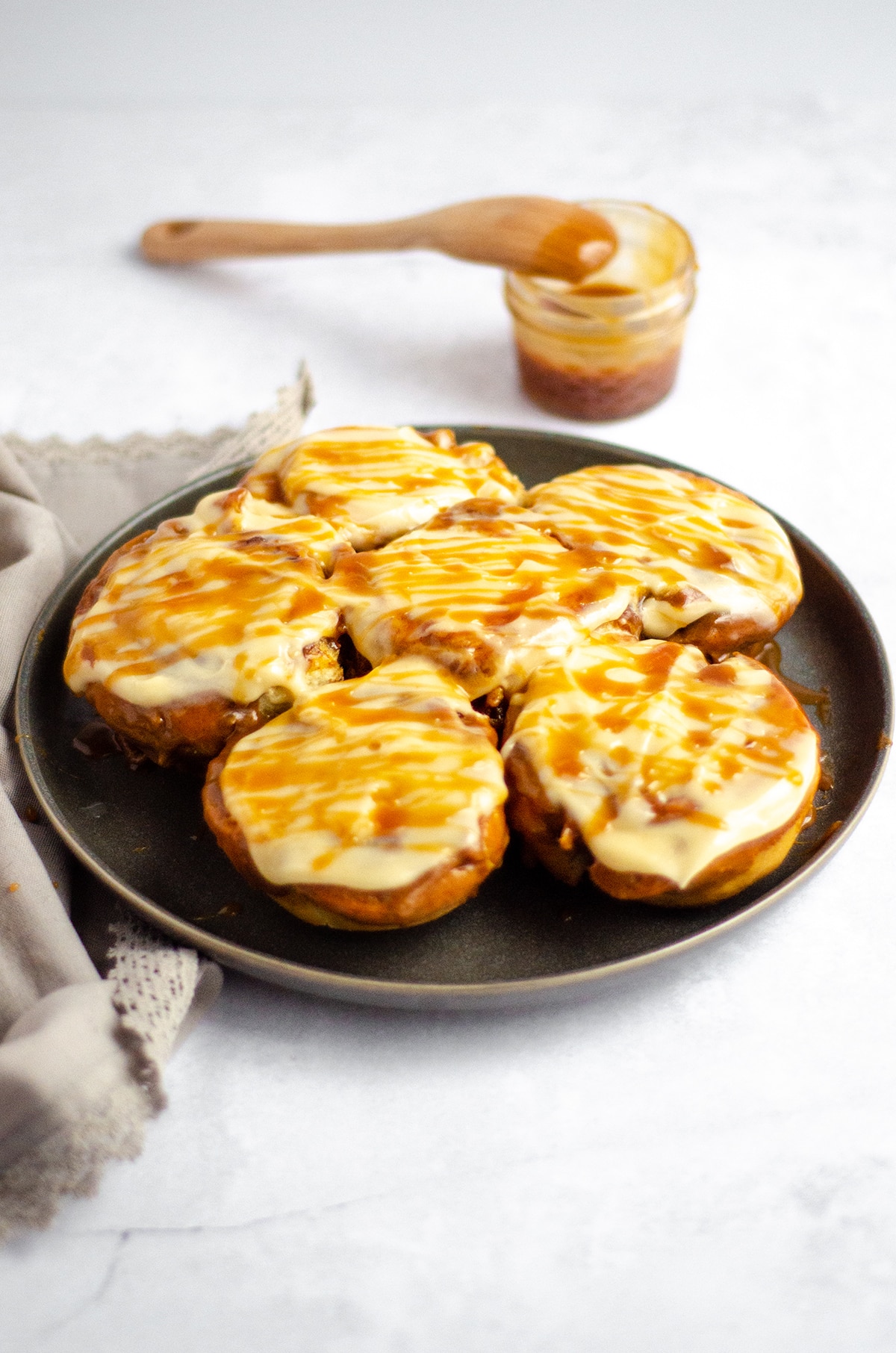 plate of caramel rolls with caramel cream cheese frosting