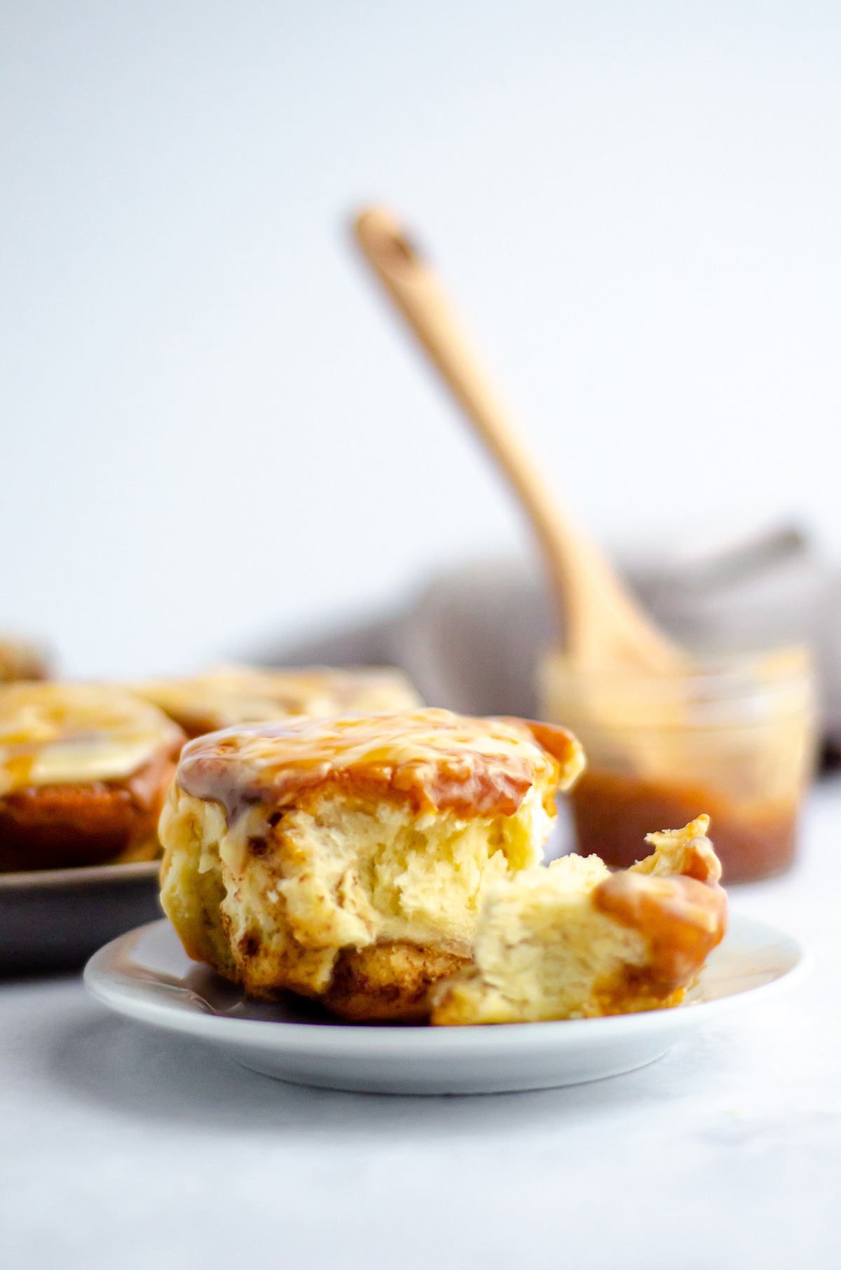 Easy small batch caramel cinnamon rolls drenched in salted caramel sauce and topped with a creamy salted caramel cream cheese frosting. via @frshaprilflours