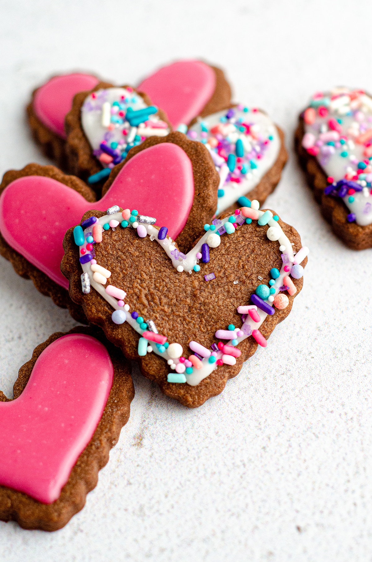 heart shaped chocolate cut-out sugar cookies decorated with icing and sprinkles