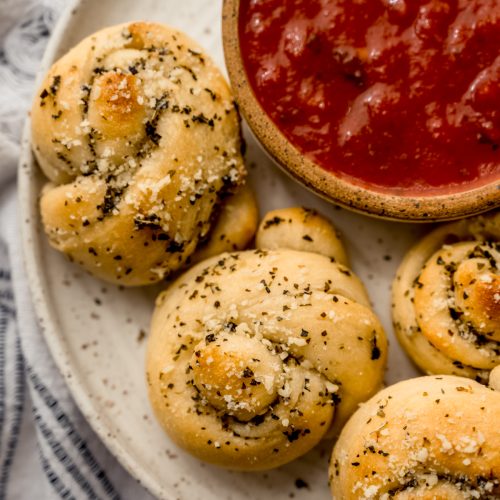 Aerial photo of homemade garlic knots on a plate.