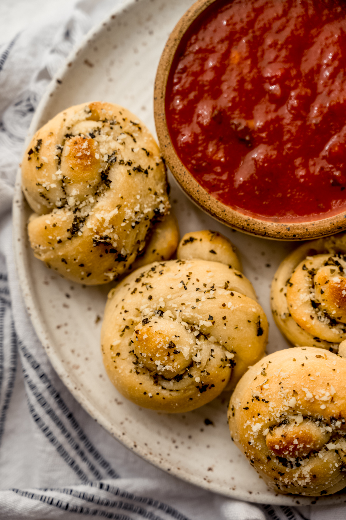 Aerial photo of homemade garlic knots on a plate.