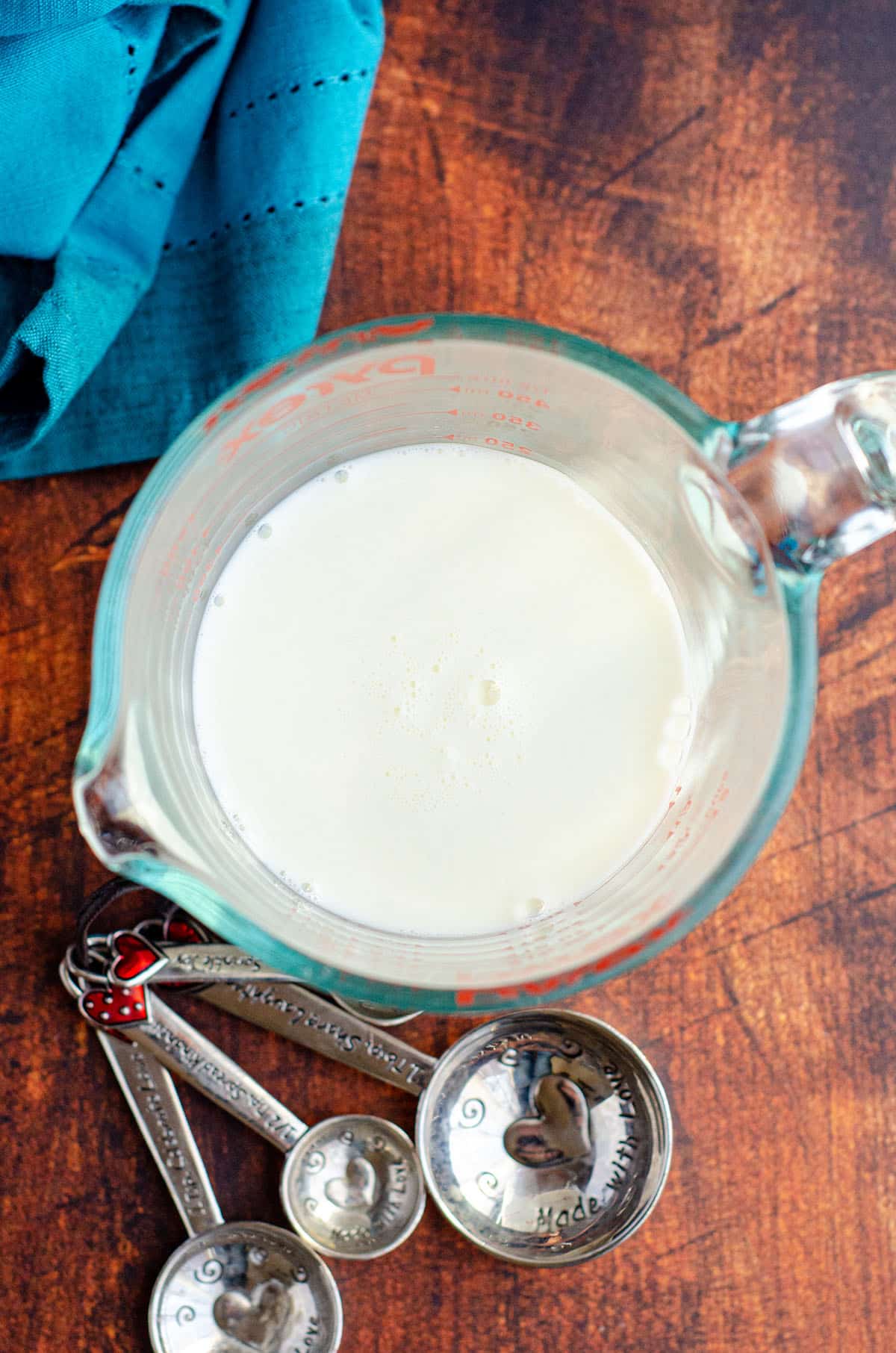 aerial photo of homemade buttermilk in a glass measuring cup