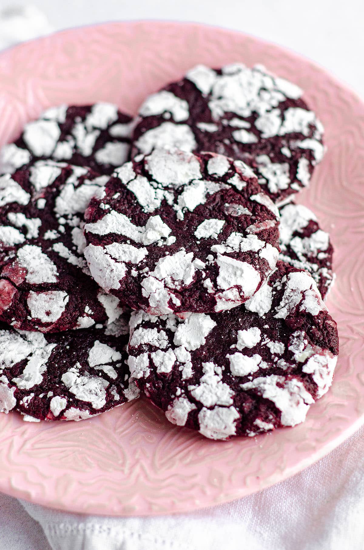 red velvet crinkle cookies on a pink plate