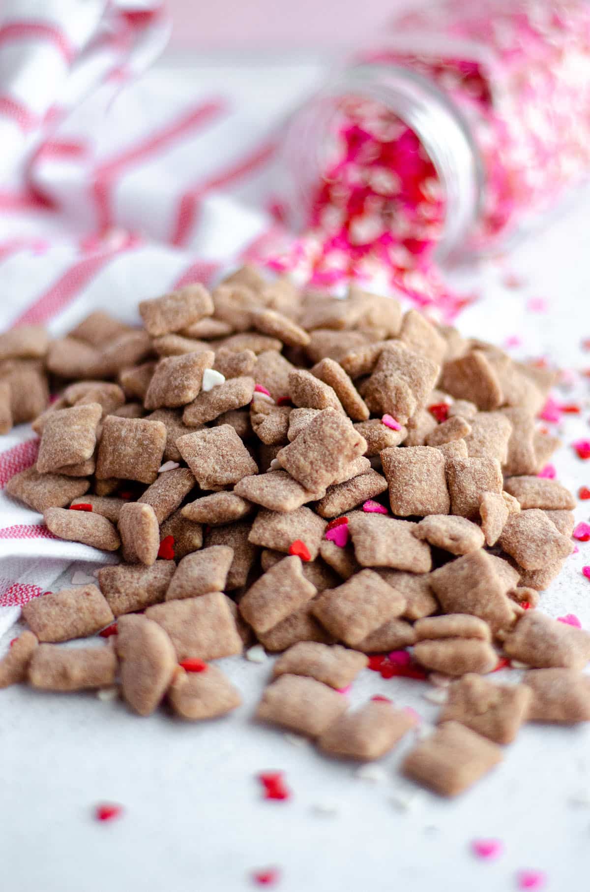 Classic puppy chow cereal snack mix gets a red velvet makeover, flavored with white chocolate and red velvet cake mix. via @frshaprilflours