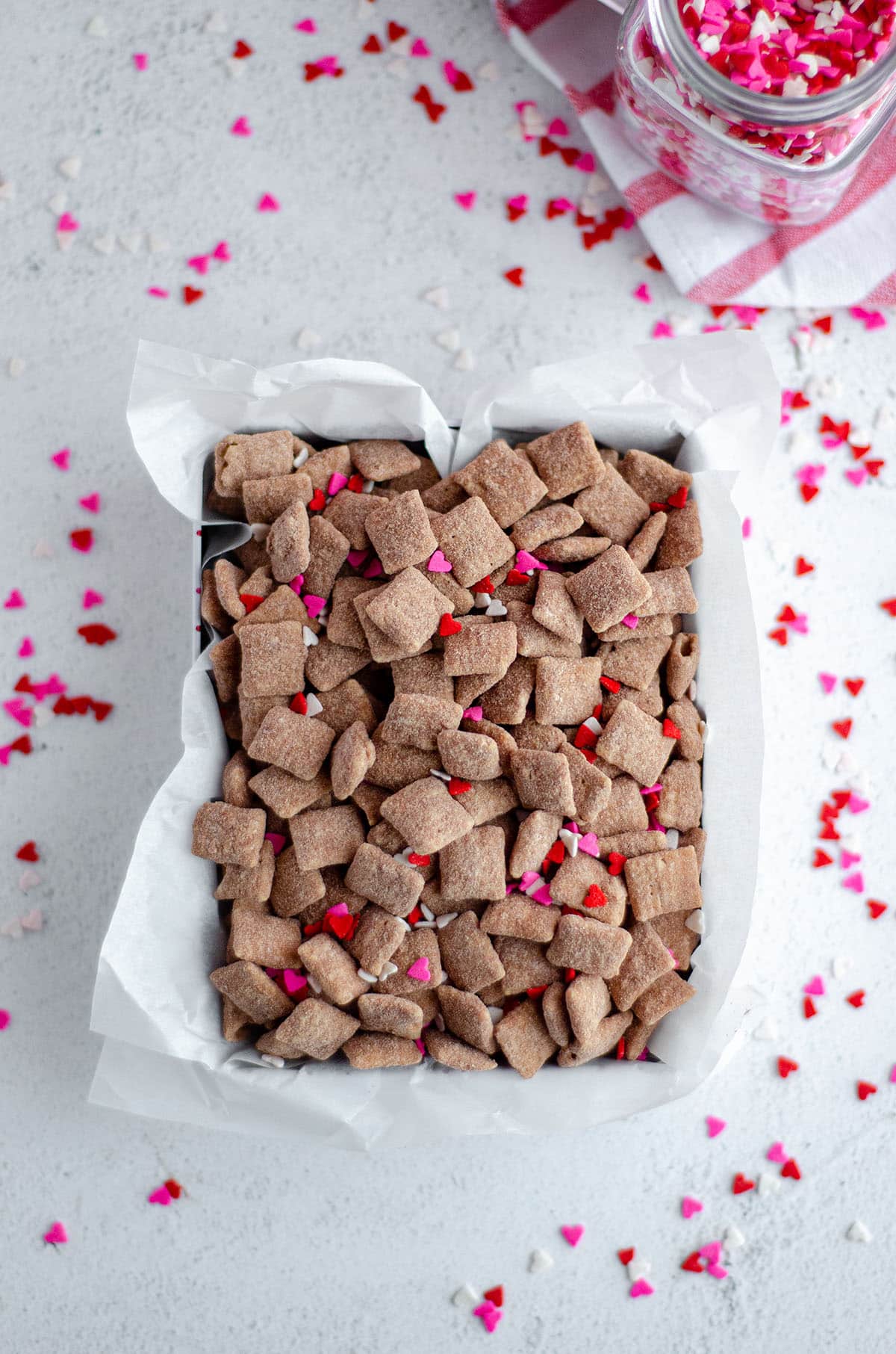 red velvet puppy chow with heart sprinkles in a treat box