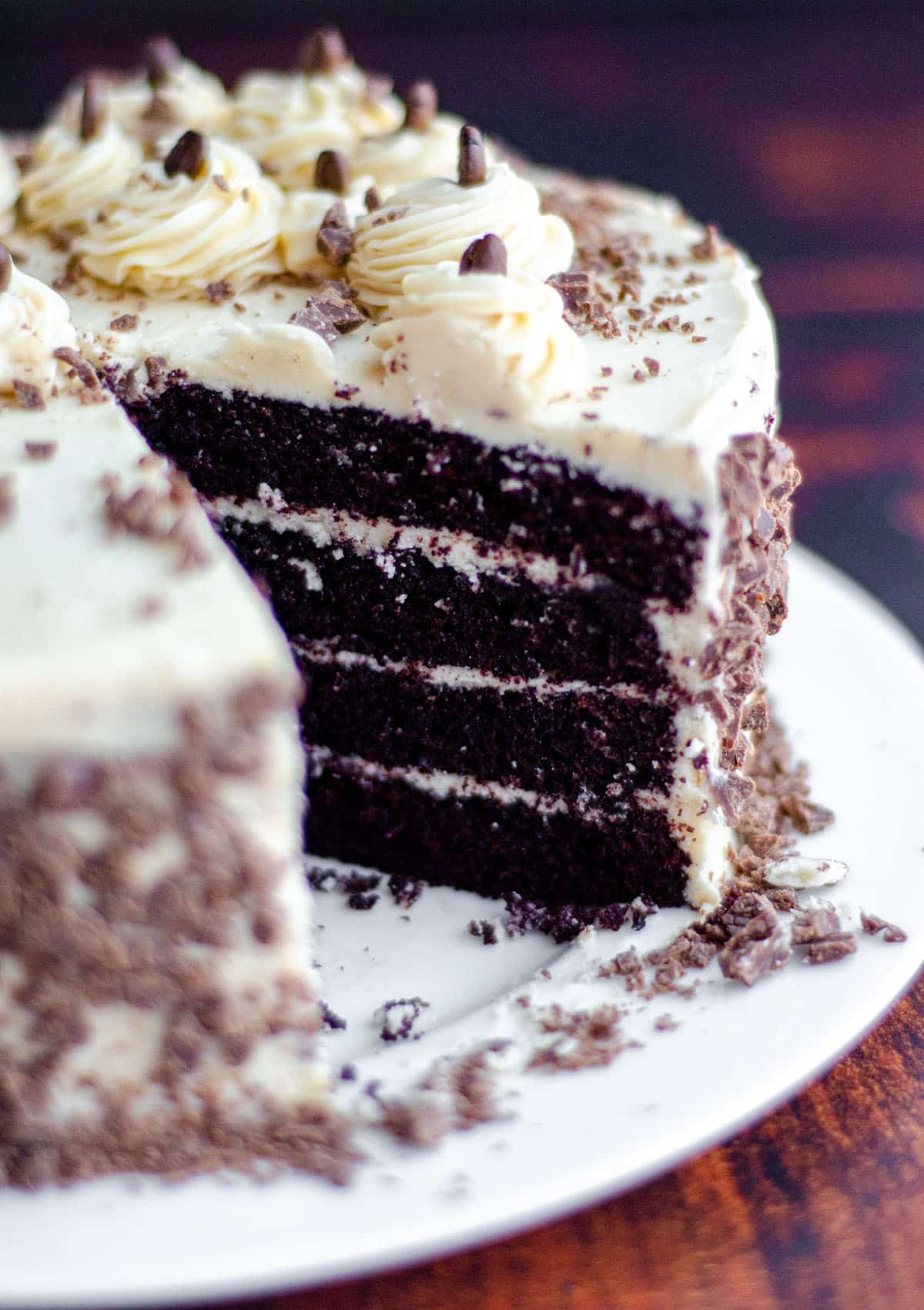 mocha cake with coffee buttercream on a plate with a slice taken out of it