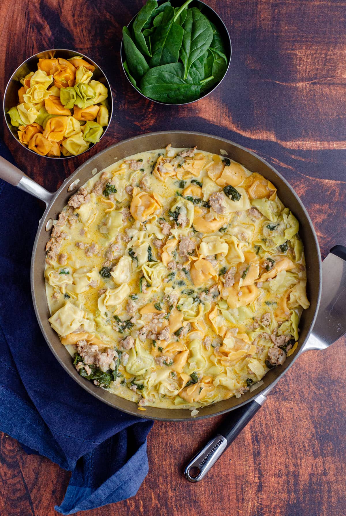 aerial photo of sausage tortellini soup in a large skillet