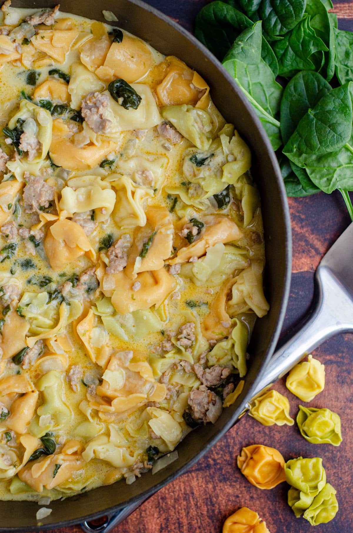 aerial photo of sausage tortellini soup in a large skillet