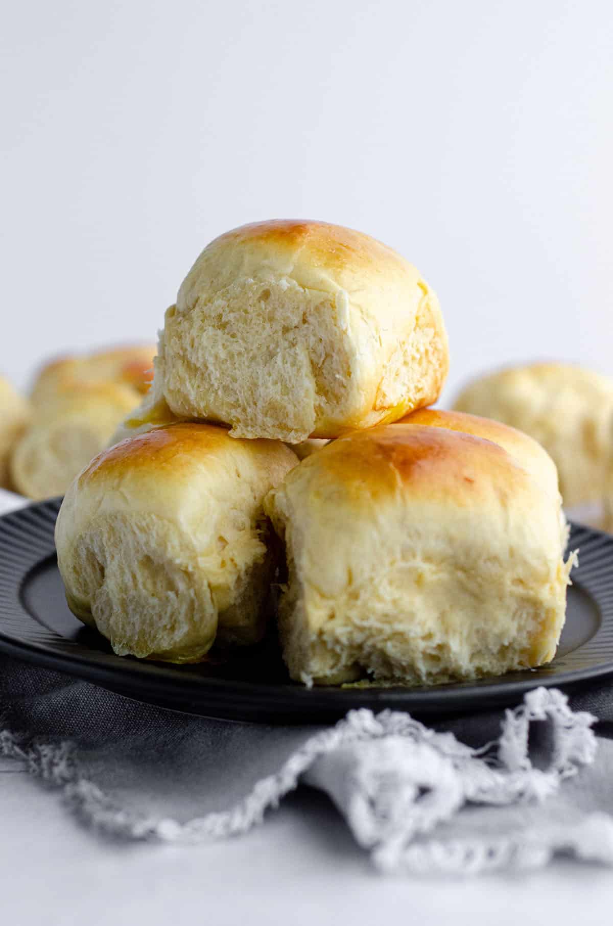 stack of easy yeast rolls on a black plate