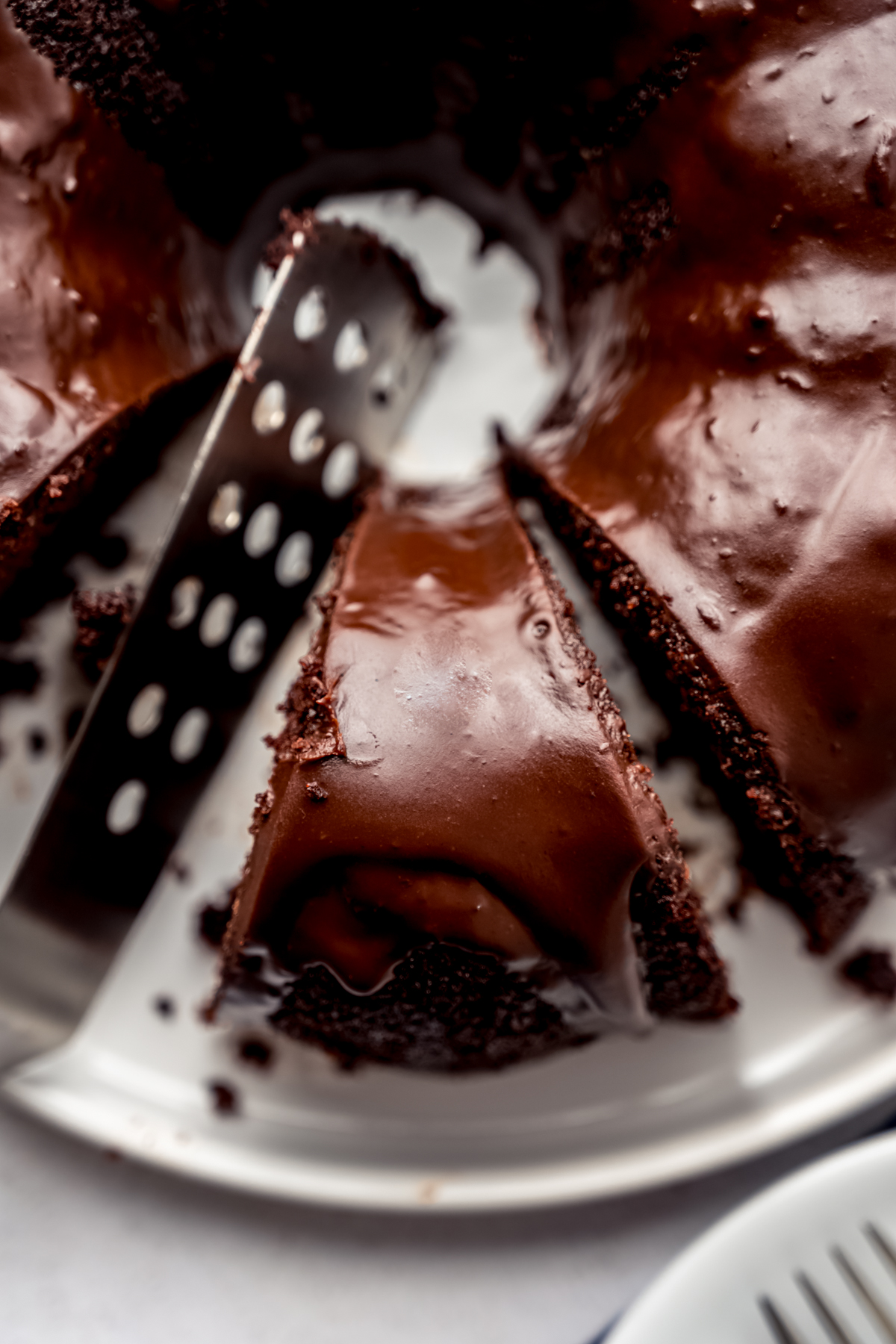 Aerial photo of a chocolate Bundt cake that has been sliced.