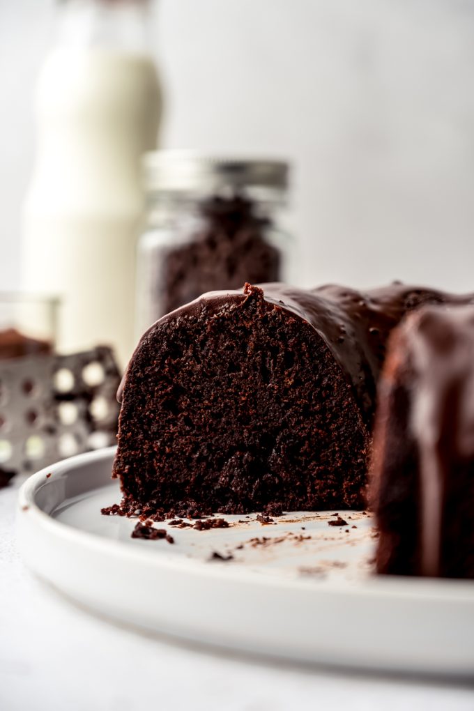 A chocolate Bundt cake that has been sliced sitting on a plate so you can see the cross section of the cake.