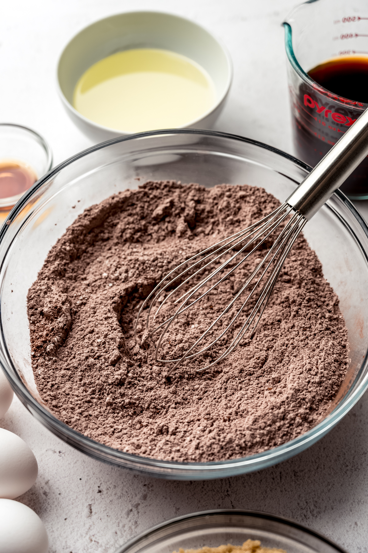 The dry ingredients for chocolate Bundt cake in a bowl with a whisk.