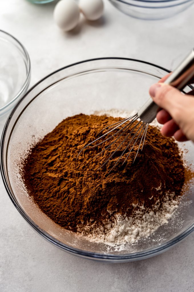 Someone is whisking together ingredients to make chocolate cake.