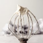 homemade whipped cream on an inverted kitchenaid stand mixer whisk attachment