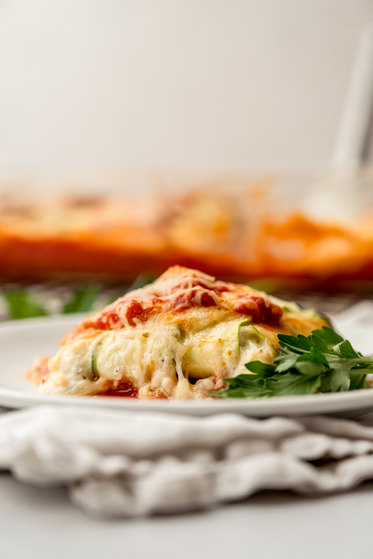 A portion of zucchini ravioli on a plate with a fork.