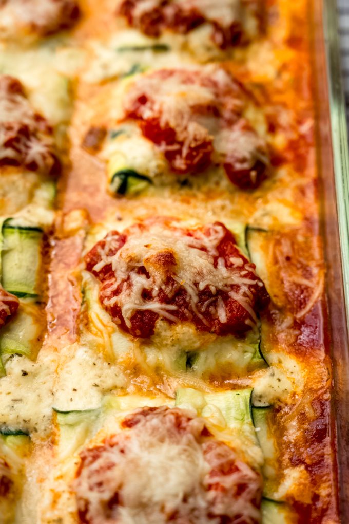 Baked zucchini ravioli in a baking dish.