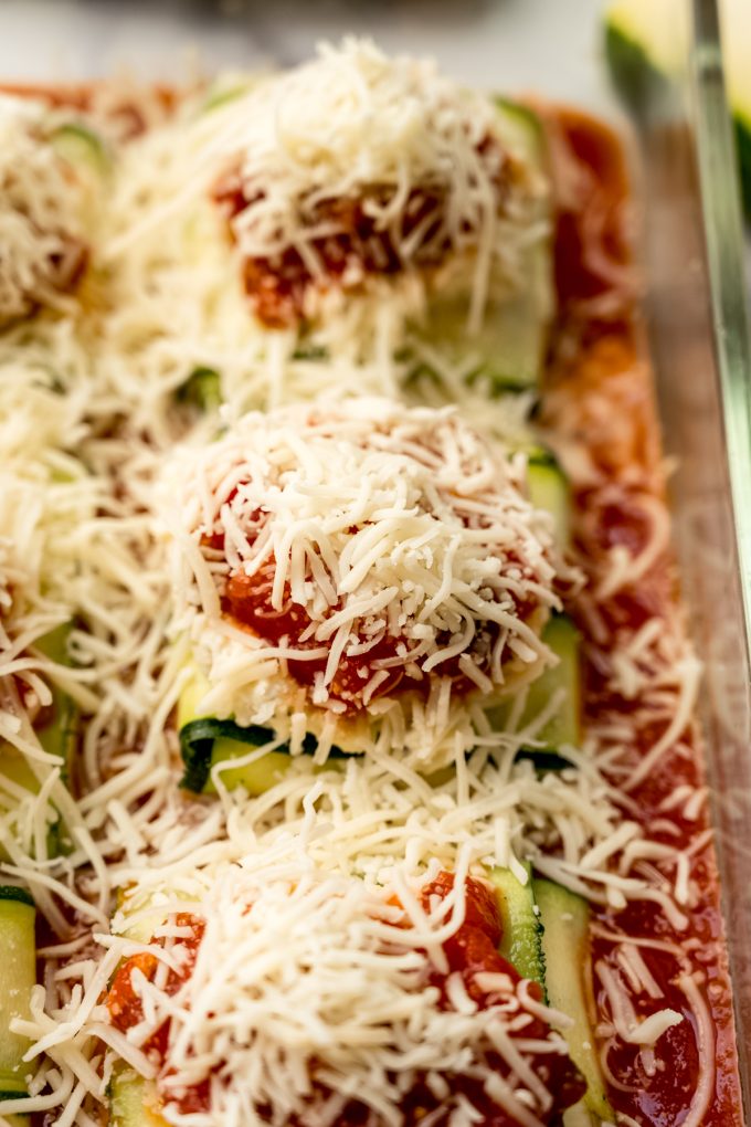 Zucchini ravioli in a baking dish before baking.