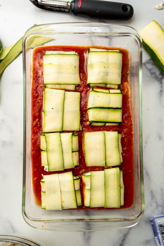 Unbaked zucchini ravioli in a baking dish.