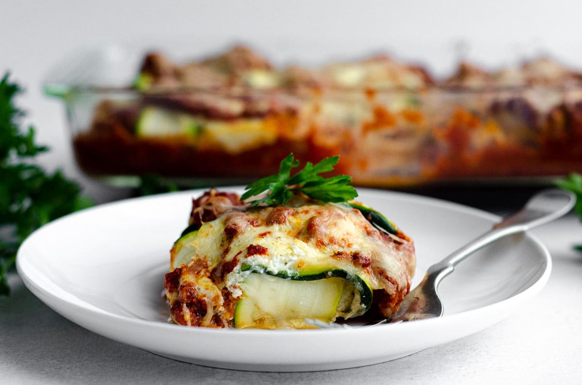 zucchini ravioli on a plate with a fork