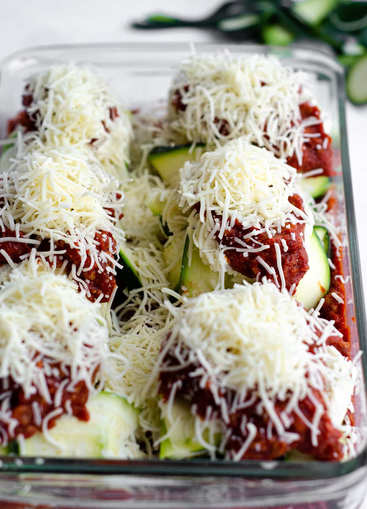 zucchini ravioli sitting in a baking dish ready to bake