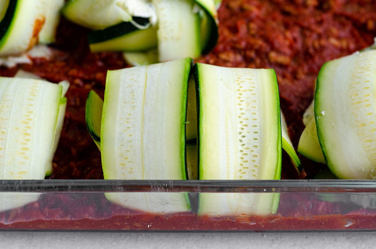 zucchini ravioli sitting in a baking dish ready to bake