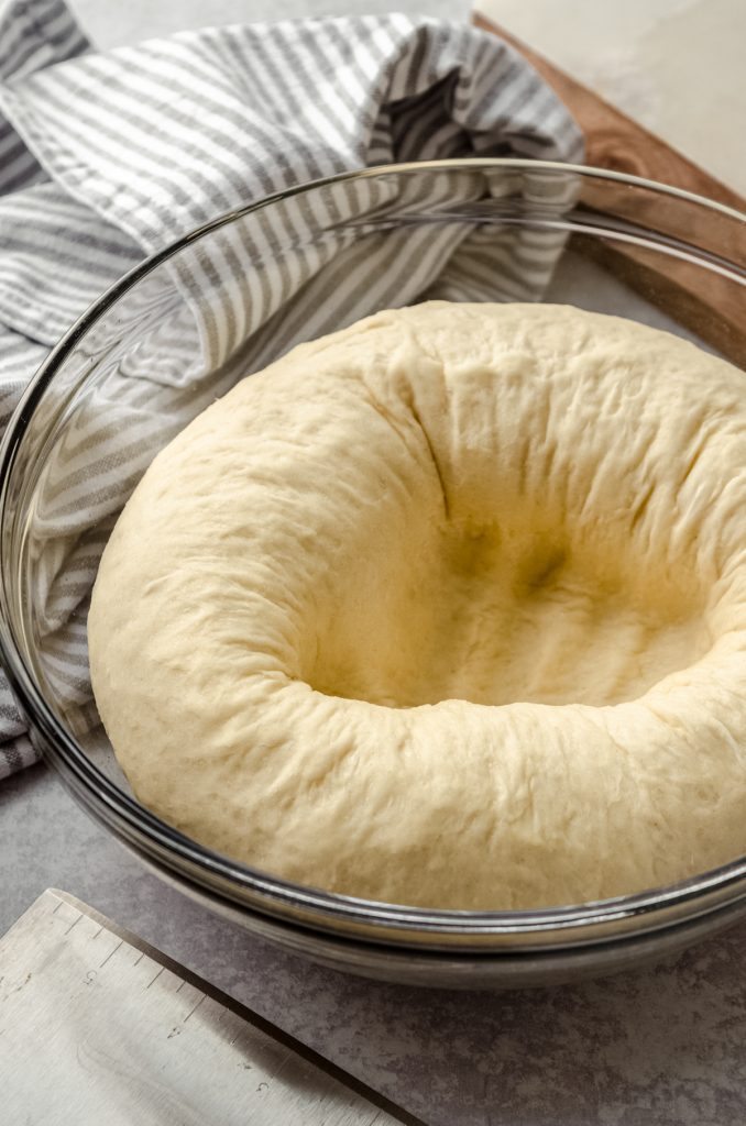 A bowl of yeast dough that has been punched down.