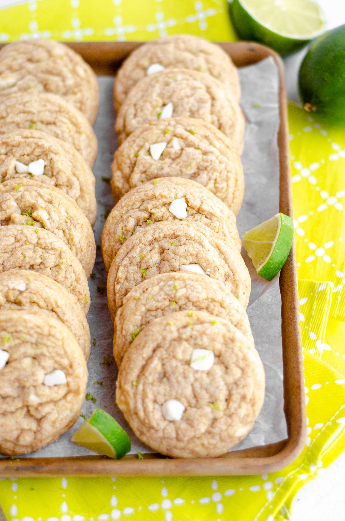 key lime cookies in a serving platter with slices of lime scattered around