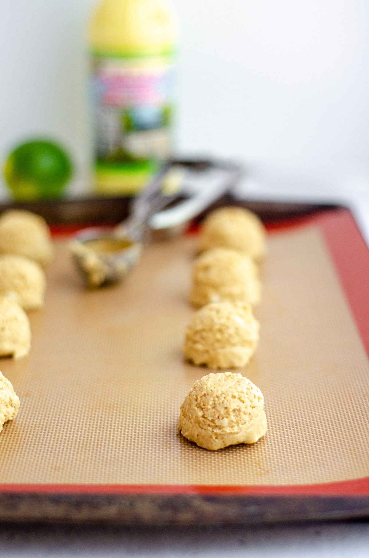 key lime cookie batter dropped into balls on a baking sheet