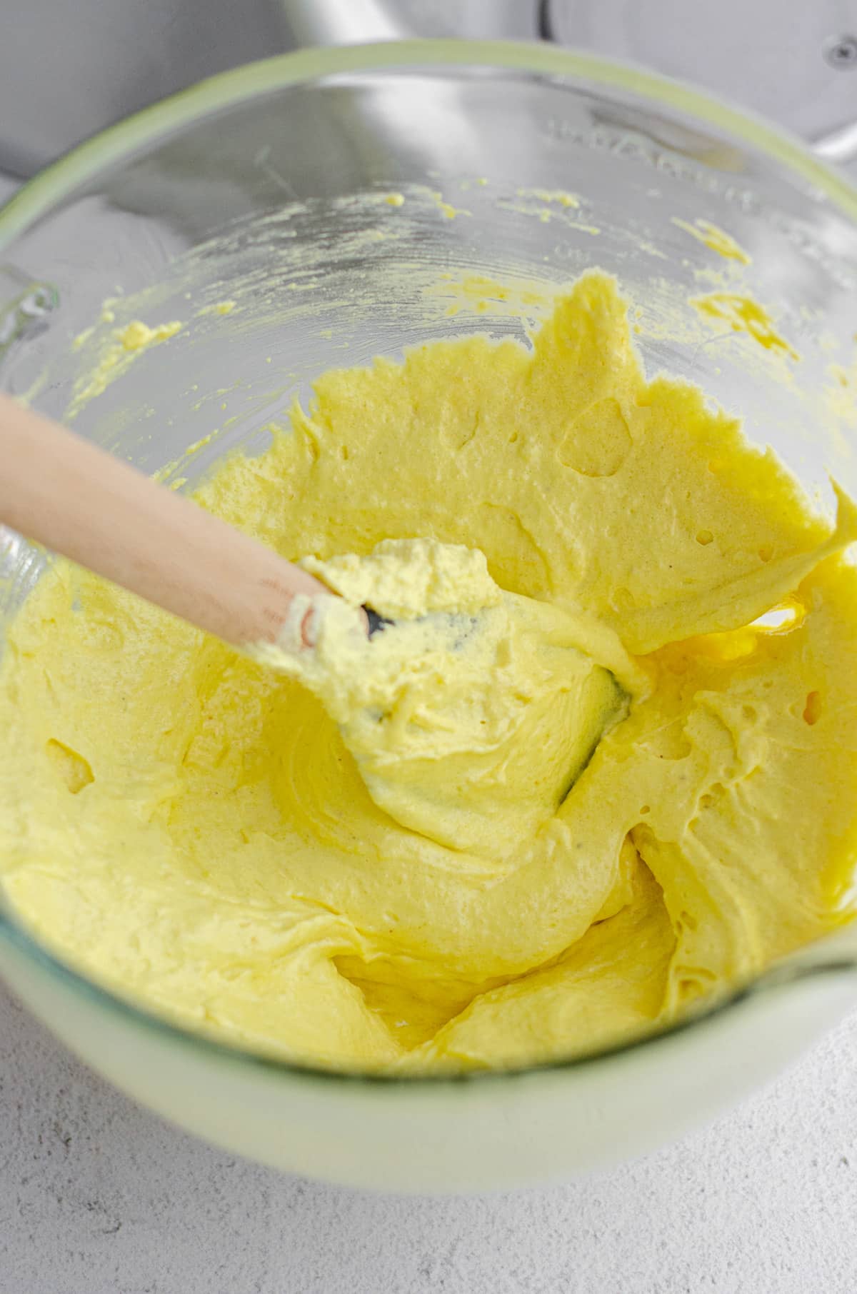 macaronage technique being used to make lemon macarons