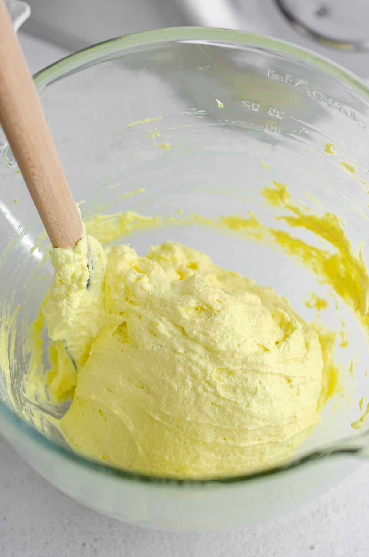 macaronage technique being used to make lemon macarons