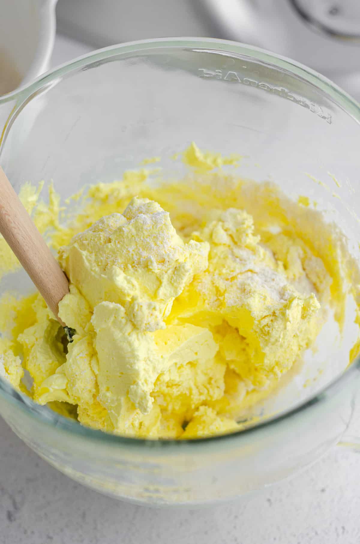 macaronage technique being used to make lemon macarons