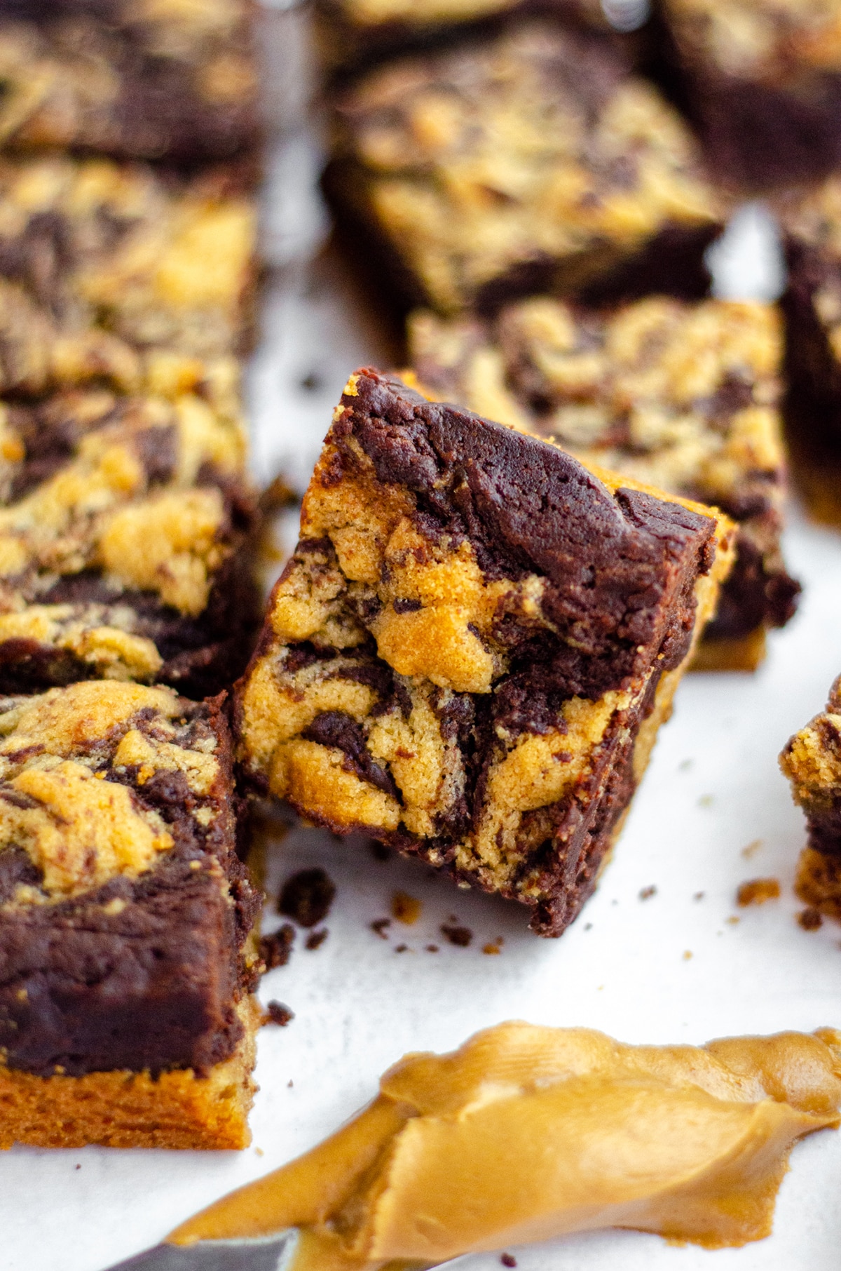 collection of peanut butter cookie brownies and one propped up so you can see the top 