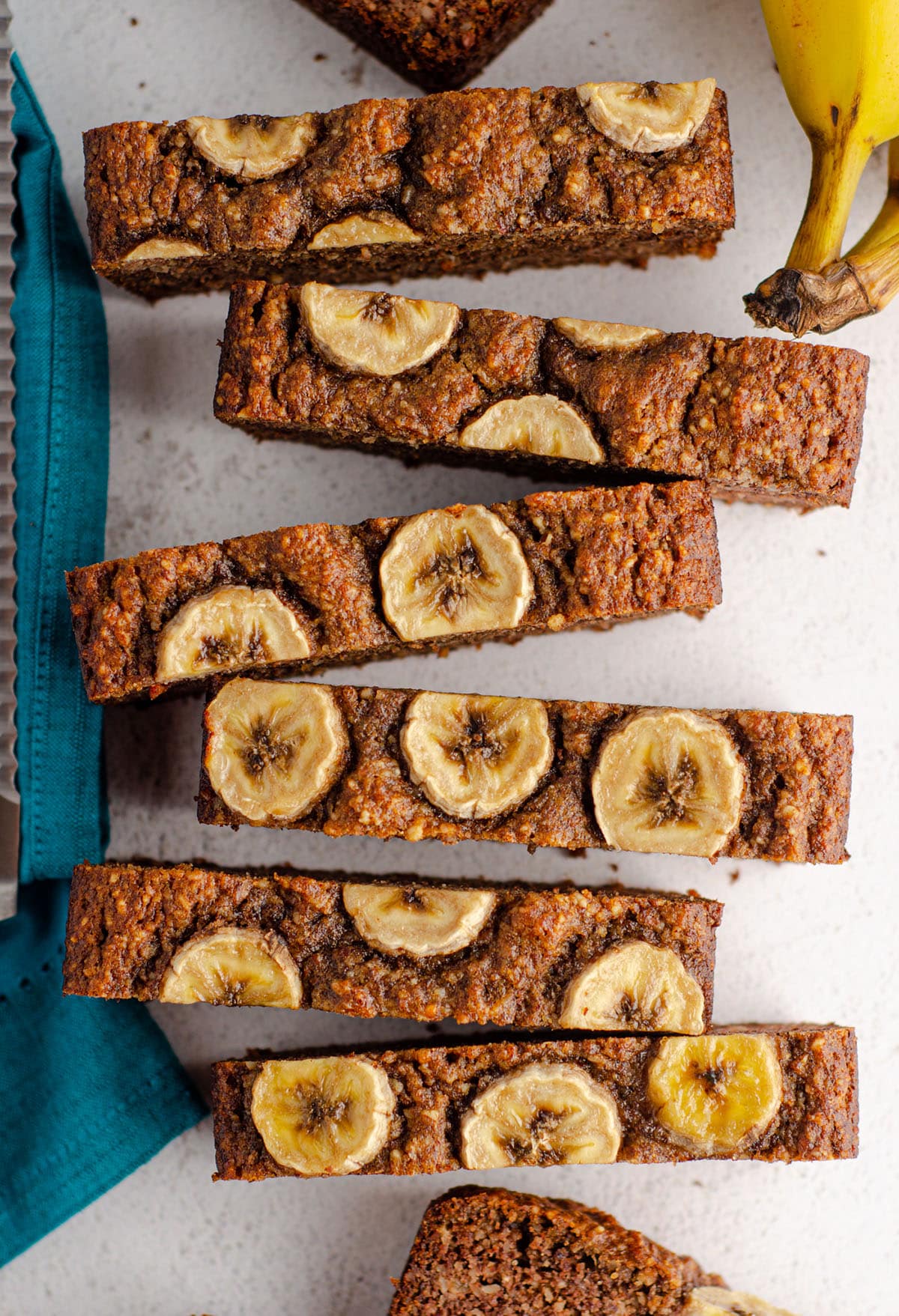 aerial photo of sliced almond flour banana bread with banana slices baked into the top