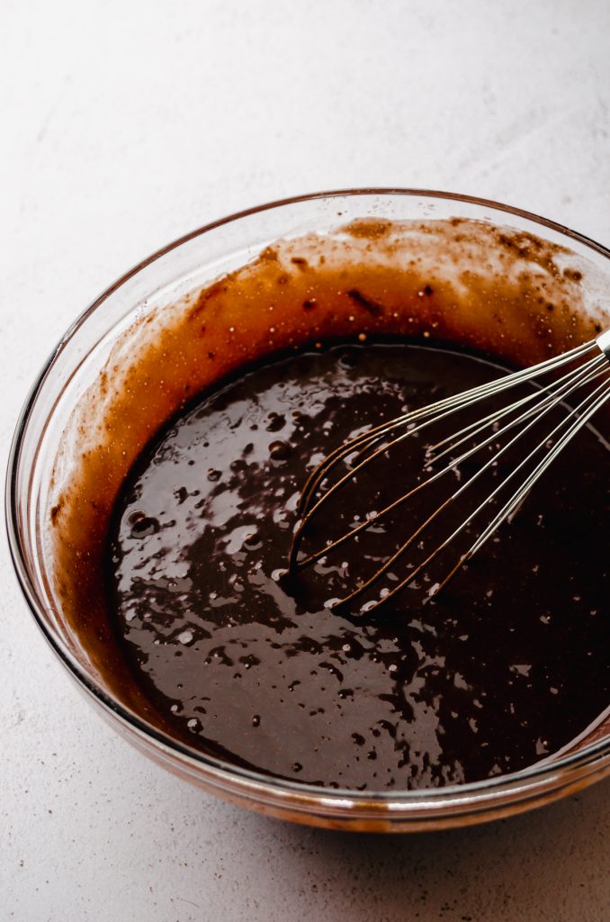 Chocolate cupcake batter in a bowl with a whisk.